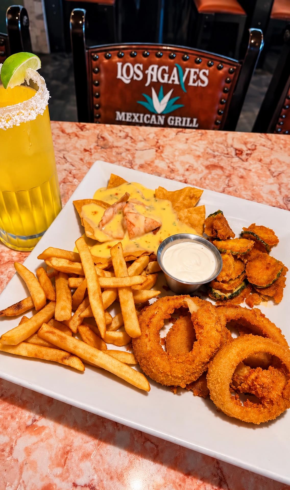Appetizer platter with queso nachos, fries, fried pickles and onion rings